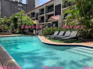 Turquoise concrete pool with tiled edge and sun loungers, a well-maintained finish after crack repair.