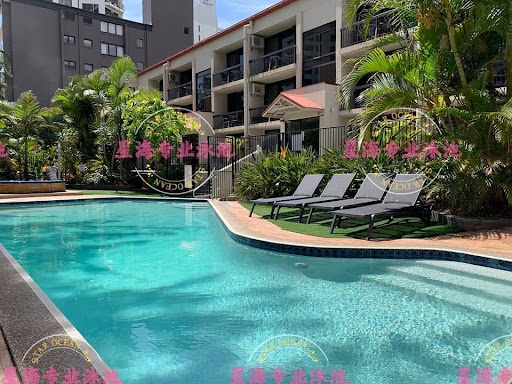 Turquoise concrete pool with tiled edge and sun loungers, a well-maintained finish after crack repair.