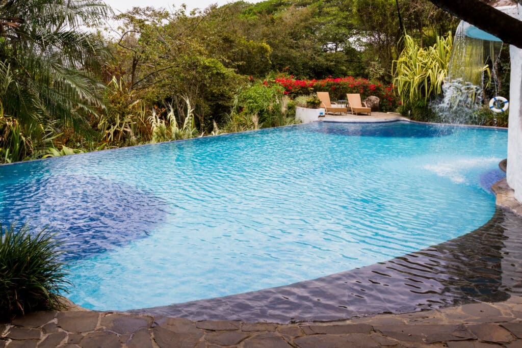 relaxing swimming pool with a waterfall in a tropi 2026 03 26 11 36 35 utc