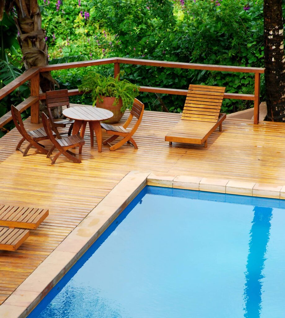 swimming pool and wooden deck surrounded by lush g 2026 03 26 11 41 29 utc scaled e1787204762353
